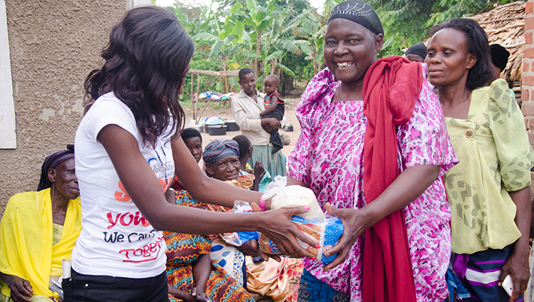 Ba_Nga_Afayo_initiative_Community_outreach_Maria_Rinah_Namatovu_Giving_out_bread