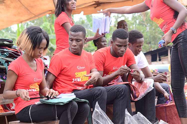 Me (on the left) preparing a backpack for handout with other vounteers