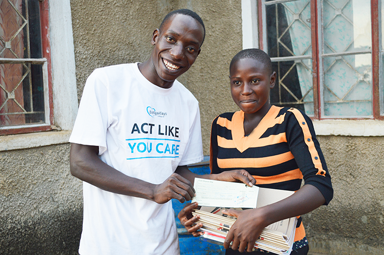 Imerida at our center in 2015 receiving school supplies and payment slip for her school fees 